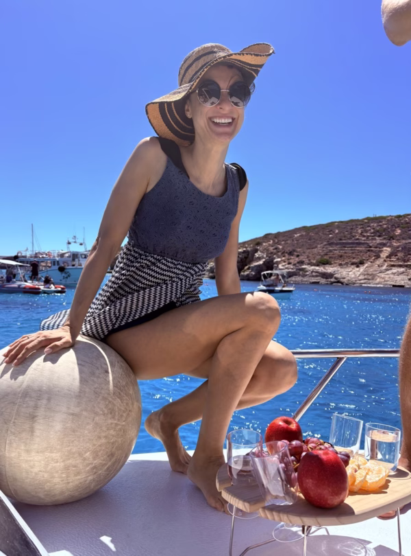 happy girl ona private boat charter at blue lagoon malta