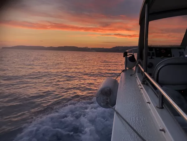 sunset at sea from a boat malta