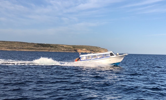 champagne on a boat in Comino, malta