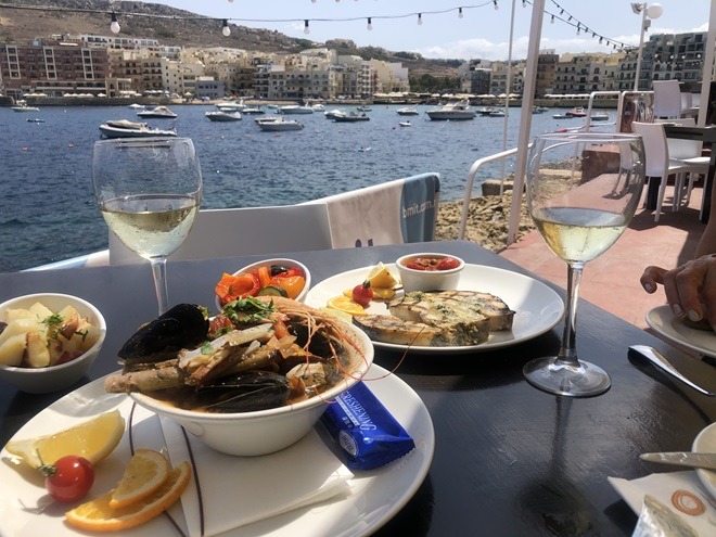 Delicious seafood with a backdrop of Marsalforn Bay