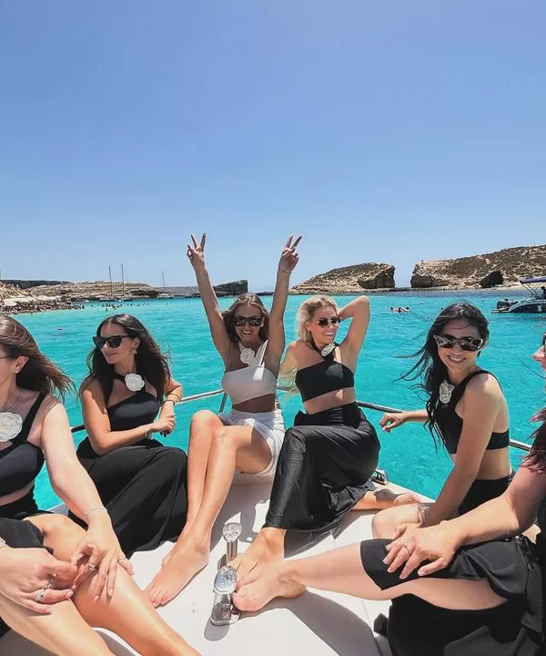 happy girls on private boat bachelorette party in blue lagoon malta