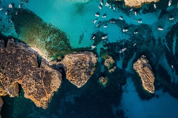 aerial view of blue lagoon comino with boats and jetski