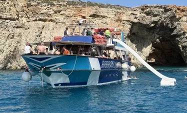 boat at crystal lagoon with a water slide and sun deck area