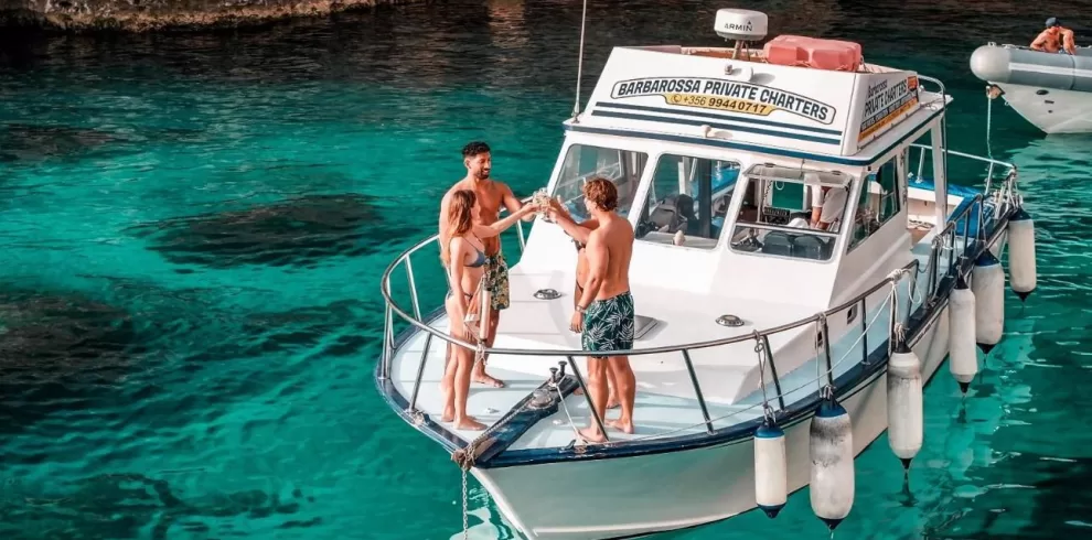 small group shared boat tour in crystal clear waters of blue lagoon comino malta