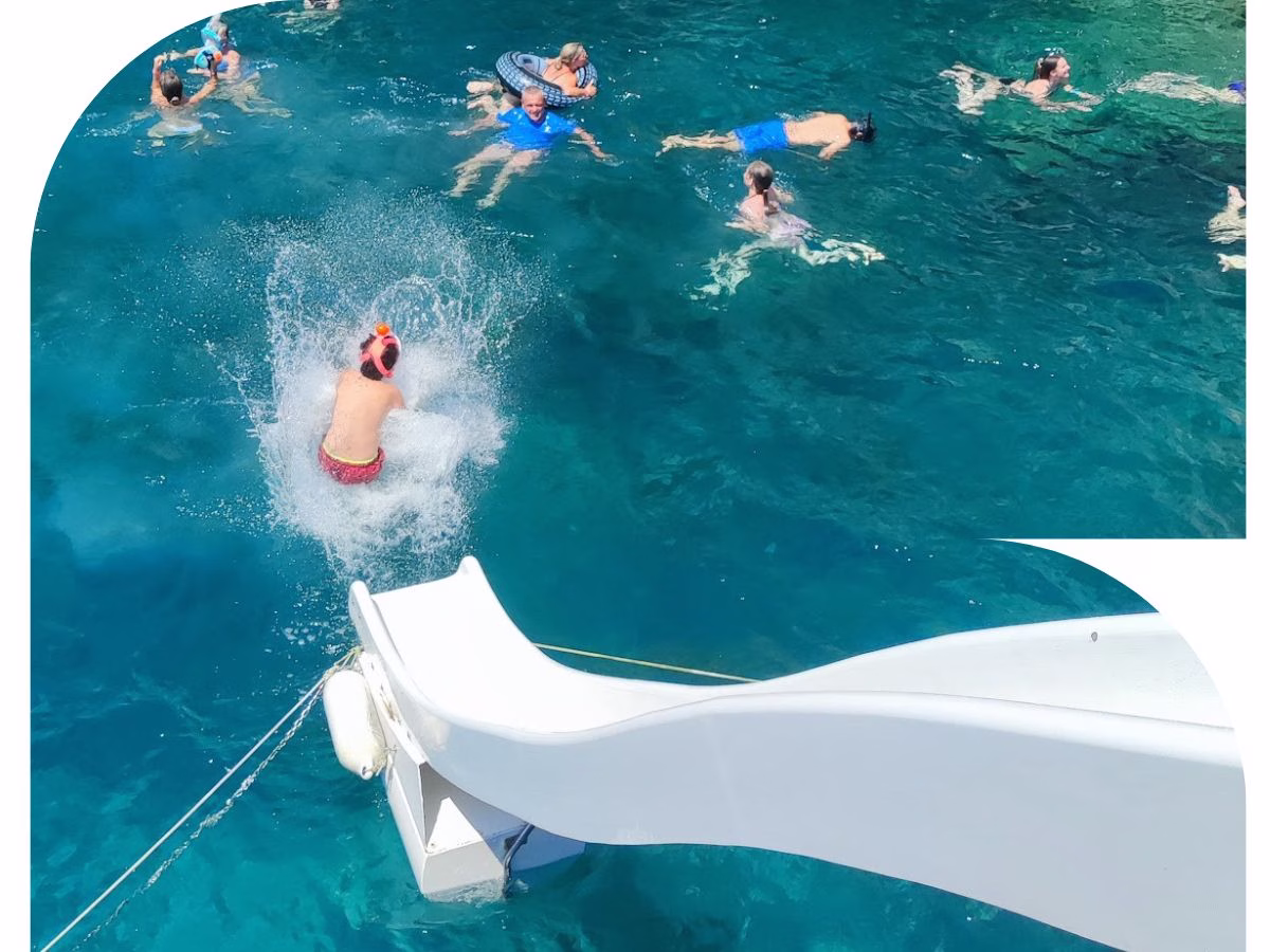 waterlside crystal lagoon boat with a water slide on a shared boat trip at blue lagoon